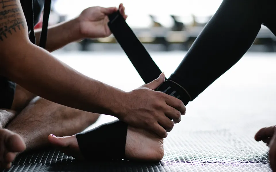 Athlete's ankle being wrapped with an elastic bandage