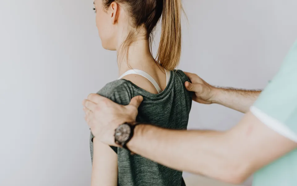 Physiotherapist mobilising a patient's shoulder