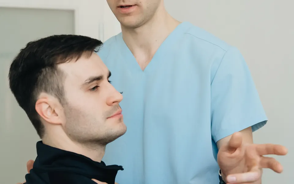Physiotherapist assessing a patient during a therapy session