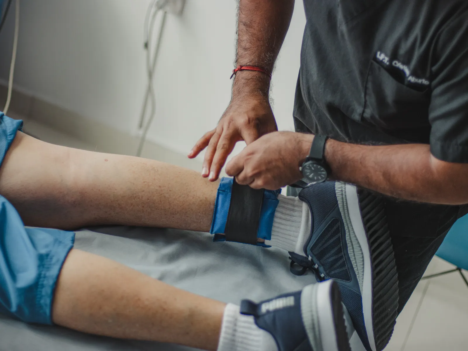 Physiotherapist guiding a patient through structured leg rehabilitation after surgery
